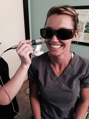 Chiropractic Santa Clarita CA Person Receiving Laser Therapy On Sinuses