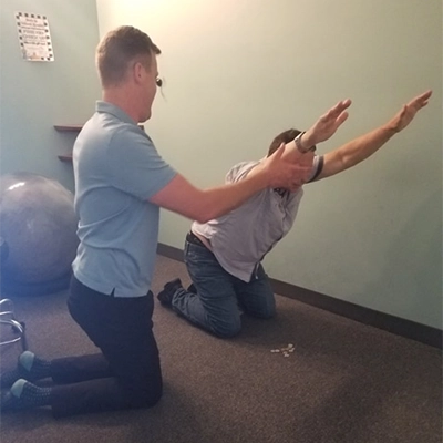 Chiropractor Santa Clarita CA Ron Bittle Assisting Rehabilitation Patient