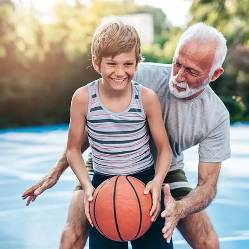Man Plaing Basketball With Grandson