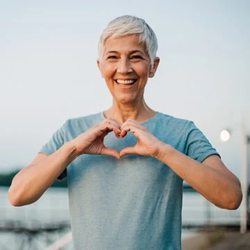 Happy Woman Making Heart Hands